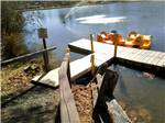 Two paddle boats docked in the lake at RUTLEDGE LAKE RV RESORT - thumbnail