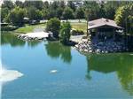 Manicured lake with small building on water's edge at LAKESIDE CASINO & RV PARK - thumbnail