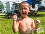 Young boy excited to be camping at CABOOSE LAKE CAMPGROUND - thumbnail