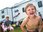 Kid at campsite at CABOOSE LAKE CAMPGROUND - thumbnail
