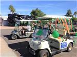 Golf carts decorated for St. Patrick's Day at DESERT SHADOWS RV RESORT - thumbnail