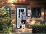 A woman and a dog standing by a door at CAMPFIRE LODGINGS - thumbnail