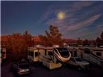 RVs and trailers parked in sites at dusk at WINE RIDGE RV RESORT & COTTAGES - thumbnail