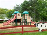 Playground with cut out of a cow on fence at THOUSAND TRAILS GETTYSBURG FARM - thumbnail