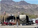 RV sites with mountains in the background at QUAIL RUN RV PARK - thumbnail