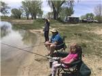 A group of people fishing in the lake at I-80 LAKESIDE CAMPGROUND - thumbnail