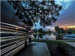 A motorhome in a site next to the water at sunset at FISHERMAN'S COVE RESORT - thumbnail