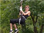 A woman ziplining at NASHVILLE SHORES LAKESIDE RESORT - thumbnail