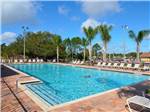 Swimming pool with outdoor seating at THOUSAND TRAILS ORLANDO - thumbnail