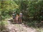 A family walking along a hiking path at SCENIC MOUNTAIN RV PARK & CAMPGROUND - thumbnail