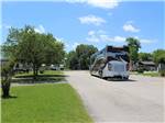 A Class A motorhome driving on one of the roads at HIDDEN LAKE RV PARK - thumbnail