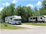 A motorhome in a back in RV site at HIDDEN LAKE RV PARK - thumbnail