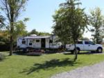 Travel trailer with white pickup truck in campsite at HTR NIAGARA - thumbnail