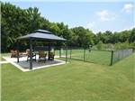 Gazebo with chairs next to the pet area at NORTHLAKE VILLAGE RV PARK - thumbnail