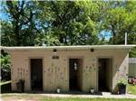 The bathhouse with trees behind at LEAFY OAKS CAMPGROUND - thumbnail