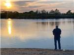 A man fishing early in the morning at KEARNEY RV PARK & CAMPGROUND - thumbnail