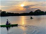 Two men kayaking at sunset at KEARNEY RV PARK & CAMPGROUND - thumbnail
