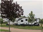 Fifth-wheel and travel trailer camping on sites at CAMPLAND RV RESORT - thumbnail