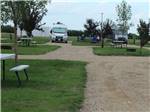 Campground with RVs on dirt sites at CAMPLAND RV RESORT - thumbnail