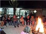 Group of people sitting around campfire at SEMINOLE CAMPGROUND - thumbnail