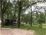 Open RV site with Class A Motorhome in distance at R CAMPGROUND - thumbnail