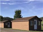 A row of rental wooden cabins at NO NAME CITY LUXURY CABINS & RV PARK - thumbnail