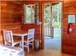 Inside of the cabin with table and chairs at KENANNA RV RESORT BY RJOURNEY - thumbnail
