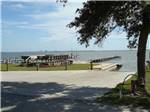 View of the waterfront with docks at WHISPERING PINES CAMPGROUND - thumbnail