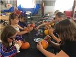 Kids painting pumpkins at WOODLAND PARK - thumbnail