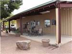 Tables and chairs in front of the office at CRAZY HORSE RV CAMPGROUNDS - thumbnail