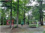 Covered red and green picnic tables at HIDDEN PARADISE CAMPGROUND - thumbnail