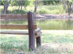 Bench looking out on water at BLUE SKY I-35 RV PARK - thumbnail
