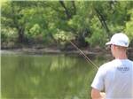 Young man fishing onsite at BLUE SKY I-35 RV PARK - thumbnail