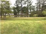 Trailers camping next to the pond at WILDERNESS RV PARK - thumbnail
