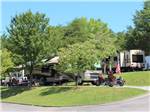 Campsite with big rig and 2 motorcycles at MILL CREEK RV PARK & VACATION RENTALS - thumbnail