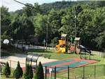 View of playground with bocci and shuffleboard courts at MILL CREEK RV PARK & VACATION RENTALS - thumbnail