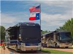 A couple of motorhomes in RV sites at PEACH COUNTRY RV PARK - thumbnail