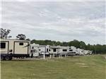 A row of RV sites by grass at LINCOLN CIVIC CENTER RV PARK - thumbnail