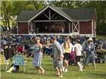 A family dancing while a band in playing on stage at DESTINATION GETTYSBURG - thumbnail