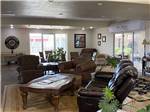 A lounge area with leather chairs and ornate table at CLOVIS RV PARK - thumbnail