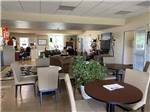A common area with chairs, tables and plants at CLOVIS RV PARK - thumbnail