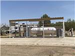 Large propane tank surrounded by fence at CLOVIS RV PARK - thumbnail