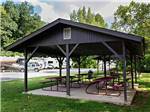 Patio area with picnic tables at BLOWING SPRINGS RV PARK - thumbnail