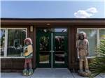Statues of Native Americans flanks office entrance at SUN RESORTS RV PARK - thumbnail