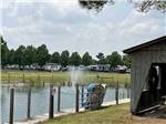 A paddle boat leaning against the fence in the lake at FARM COUNTRY CAMPGROUND - thumbnail