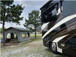 A motorhome parked next to the pavilion at FARM COUNTRY CAMPGROUND - thumbnail