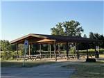Pavilion with multiple picnic tables for gatherings at SOARING EAGLE HIDEAWAY RV PARK - thumbnail