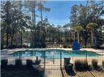 Pool surrounded by waist-high wrought-iron fence at LAKE JASPER RV VILLAGE - thumbnail