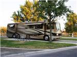 Motorhome in site with patio with chairs at LAKE JASPER RV VILLAGE - thumbnail