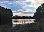 A view of the lake at dusk at LAKE JASPER RV VILLAGE - thumbnail